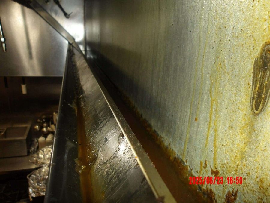 Grease-caked grease trough before cleaning by Oregon Hood Cleaning